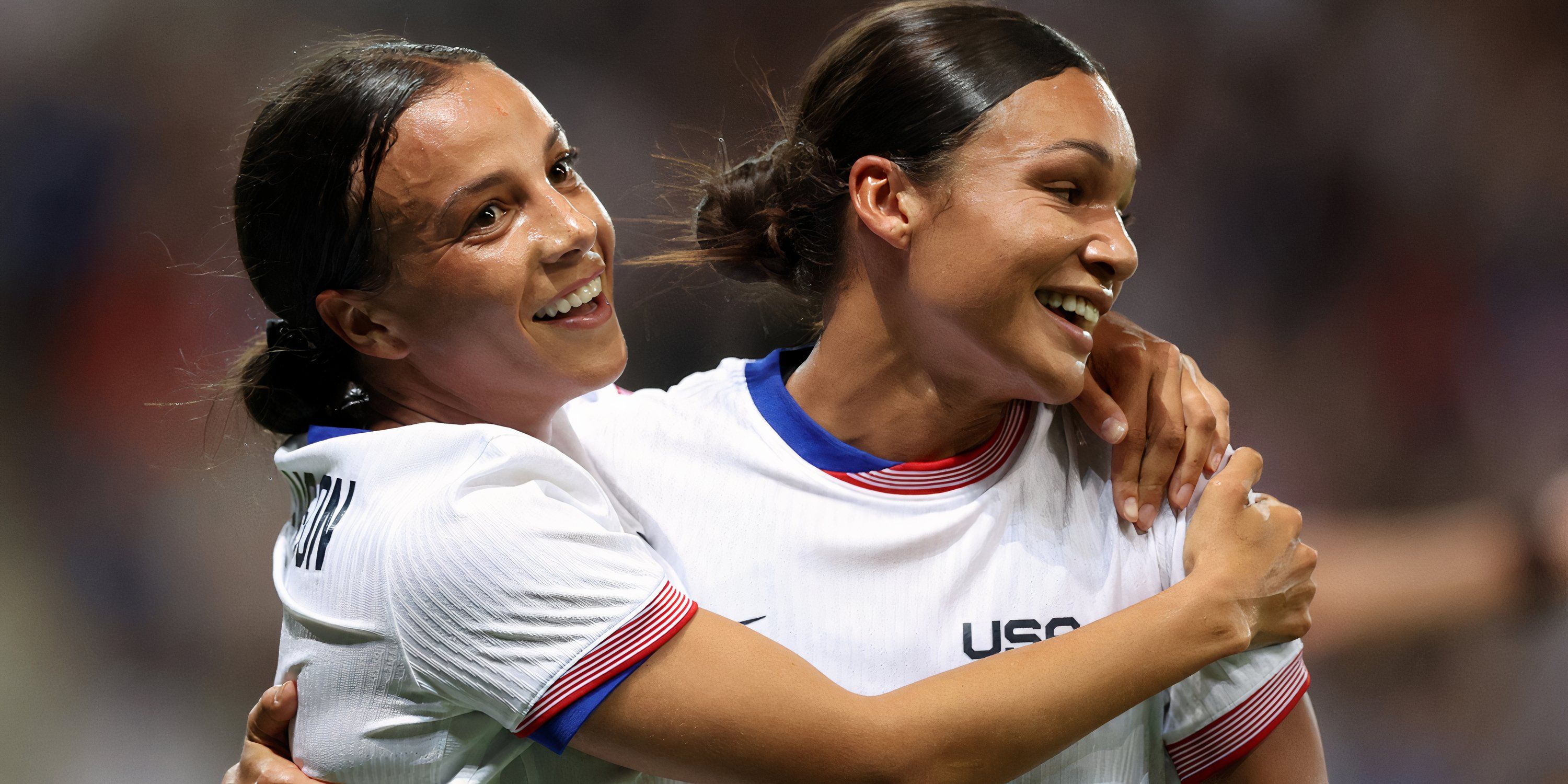 Mallory Swanson and Sophia Smith celebrate a goal against Zambia at the 2024 Olympics